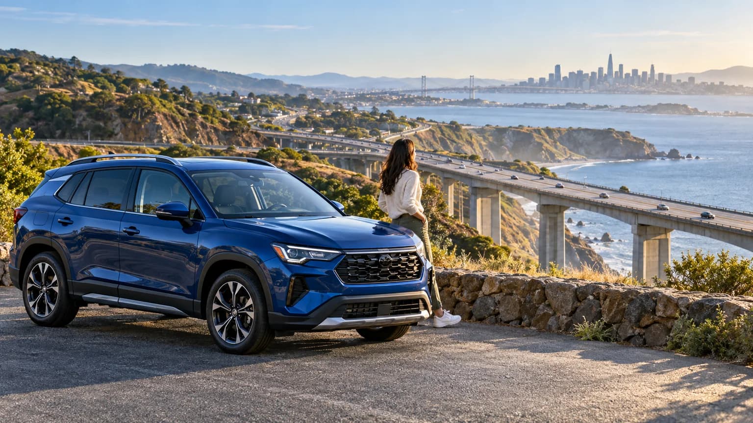 Blue vehicle overlooking California roads and bridge infrastructure